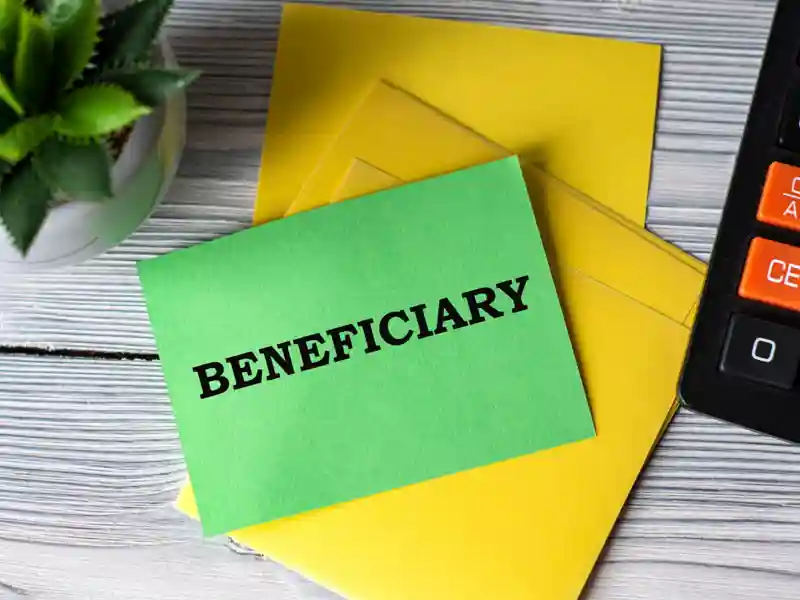 Green note reading Beneficiary on top of envelopes