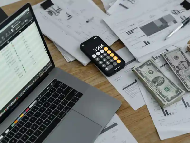 Laptop cellphone and cash.