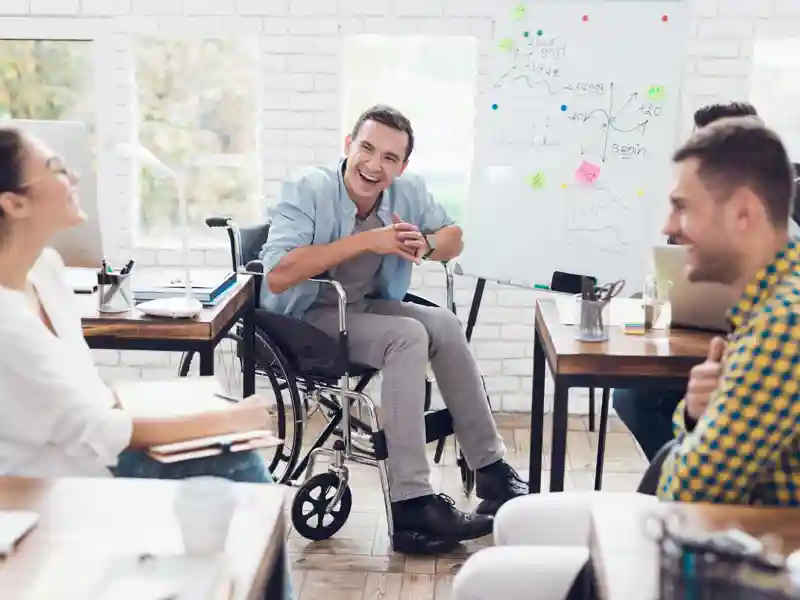 A man in a wheelchair demonstrates business graphics.