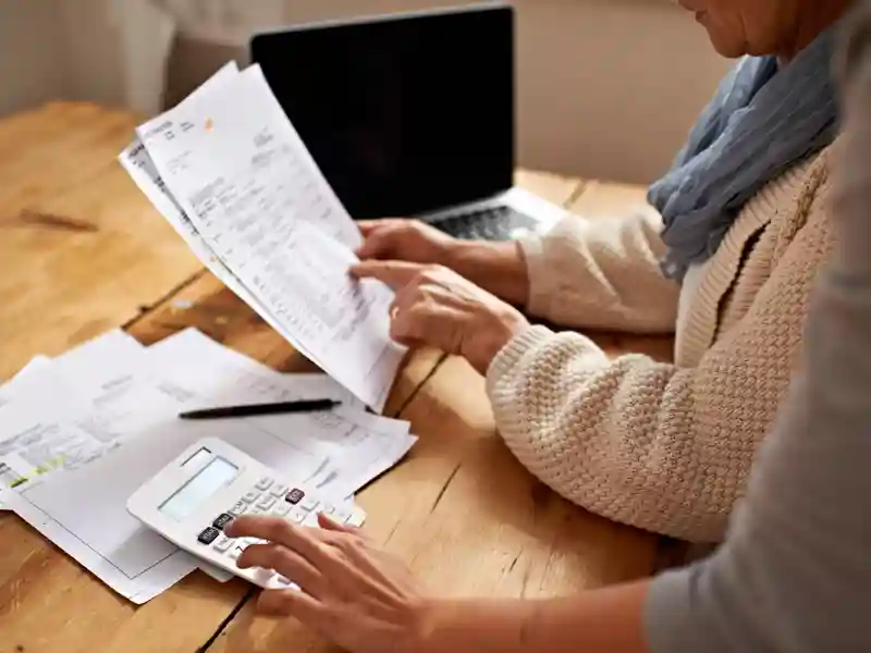 Couple doing financial paperwork at home.