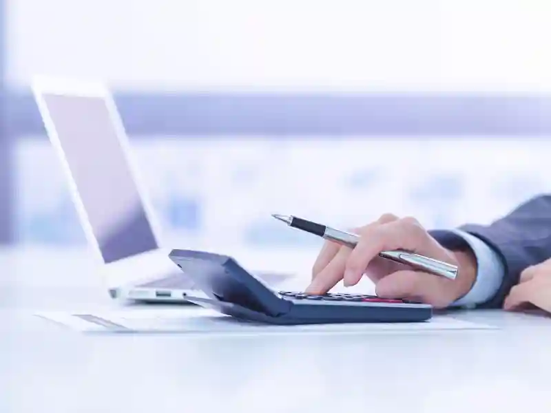 Businessman analyzing investment charts with laptop.